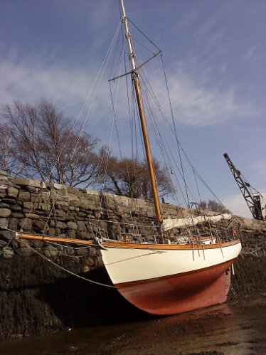 Wooden Classic Gaff cutterfor sale Dreva dried out alongside - Showing her long keel to good effect
